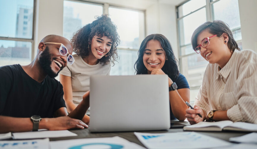 A young marketing team in office together, on laptop video call with boss and discuss advertising strategy plan. Business meeting about digital statistics, graphs and data charts for business meeting